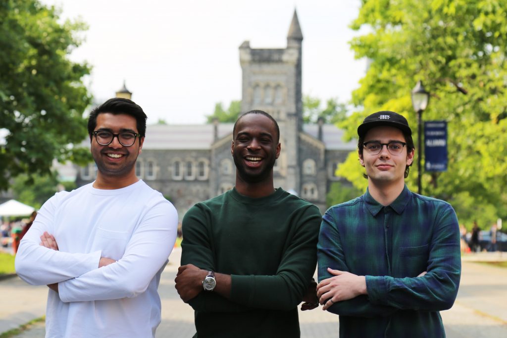 Spencer Canner with two classmates standing infront of an old building.